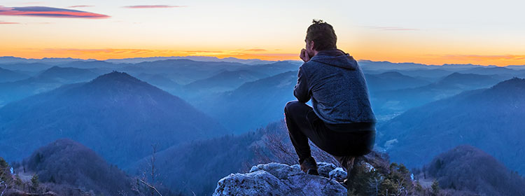Man Looking Out Over Mountain Range
